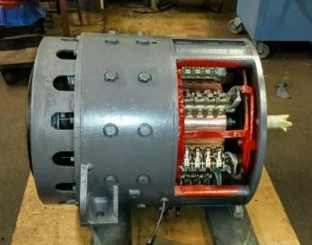 Close-up of a disassembled electric motor, showcasing its inner wiring and components with a gray exterior and red detailing